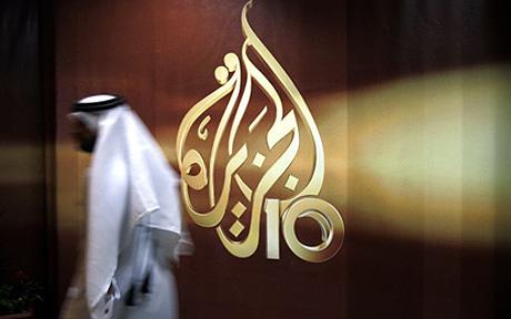 QATAR AL JAZEERA AL JAZEERA TV CHANNEL...A Qatari employee of Al Jazeera Arabic language TV news channel passes by the logo of Al Jazeera in Doha, Qatar, Wednesday Nov. 1, 2006. The English language offshoot of Qatar based pan-Arab television news channel Al Jazeera said on Tuesday it will start broadcasting on November 15, 2006. (AP Photo/Kamran Jebreili)